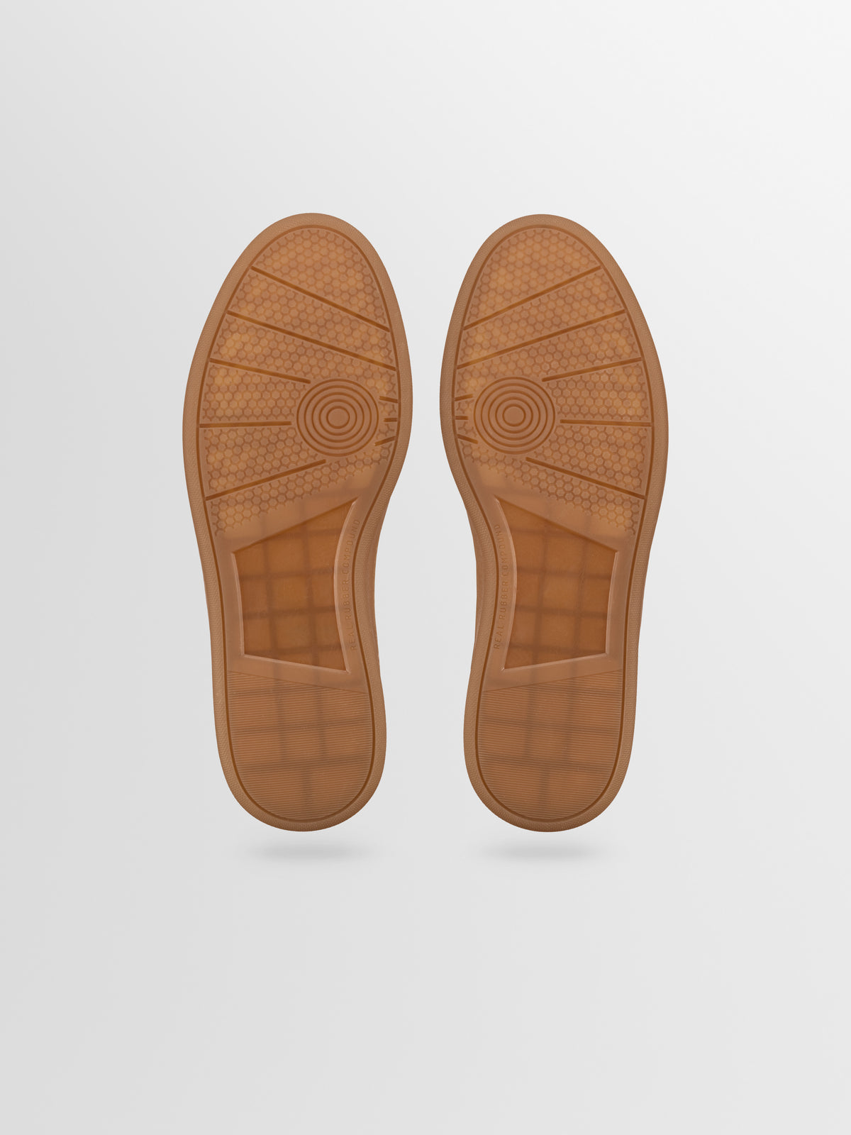 A pair of brown rubber shoe soles from men